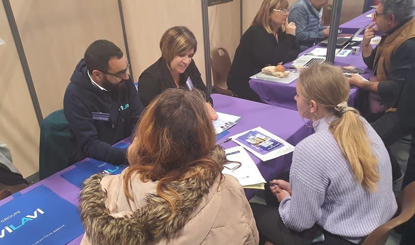 Deux collaborateurs de VILAVI en discussion avec deux jeunes femmes